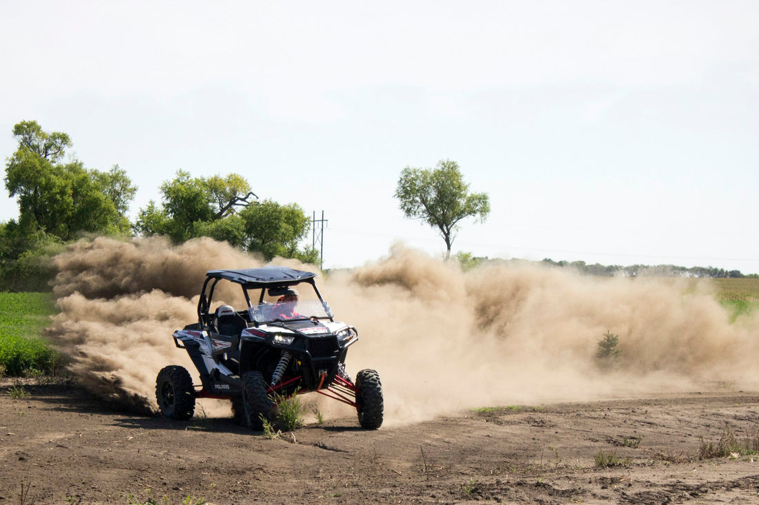 Side-by-side UTV in action on a dirt course