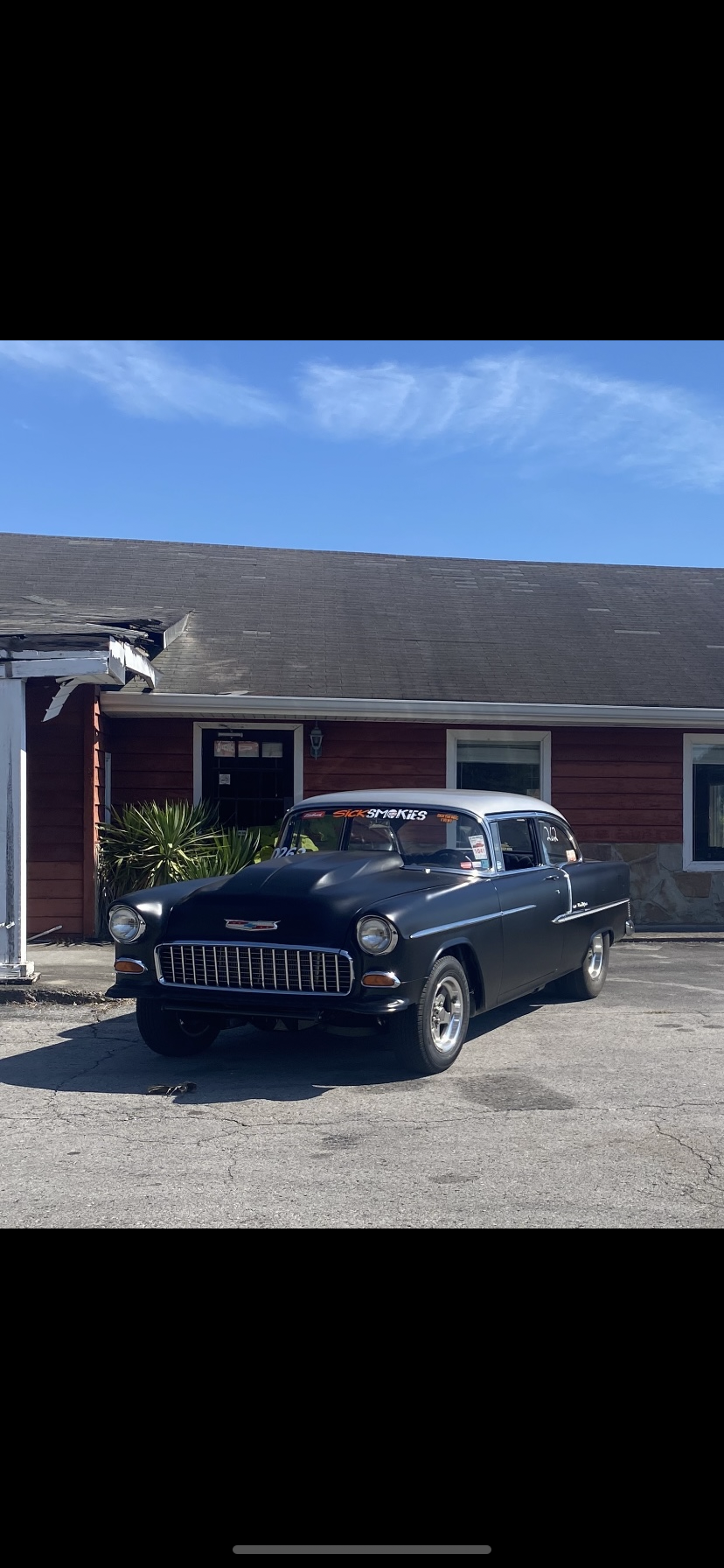 Sammy Washington’s black 1955 Chevrolet Bel Air outside Sammy’s Speed Shop
